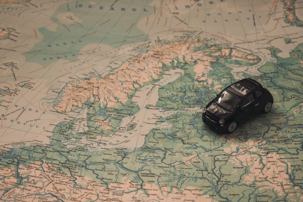 Mastering the First Impression: Your intriguing post title goes here A miniature black car on a detailed map of Scandinavia, symbolizing travel adventures.